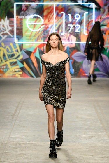 Lindsey Wixson on a runway in a leopard sequined mini dress