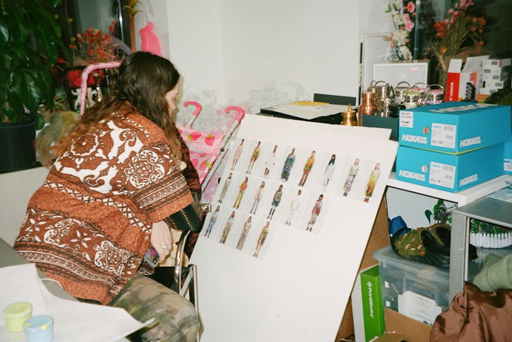 Designer Hillary Taymour finalizes working on the mood board for the show