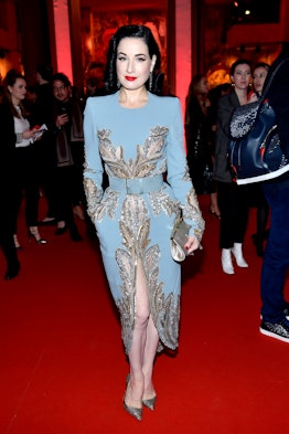 Dita Von Teese posing for a photo at the exhibition opening of “L’Exibition[niste]”