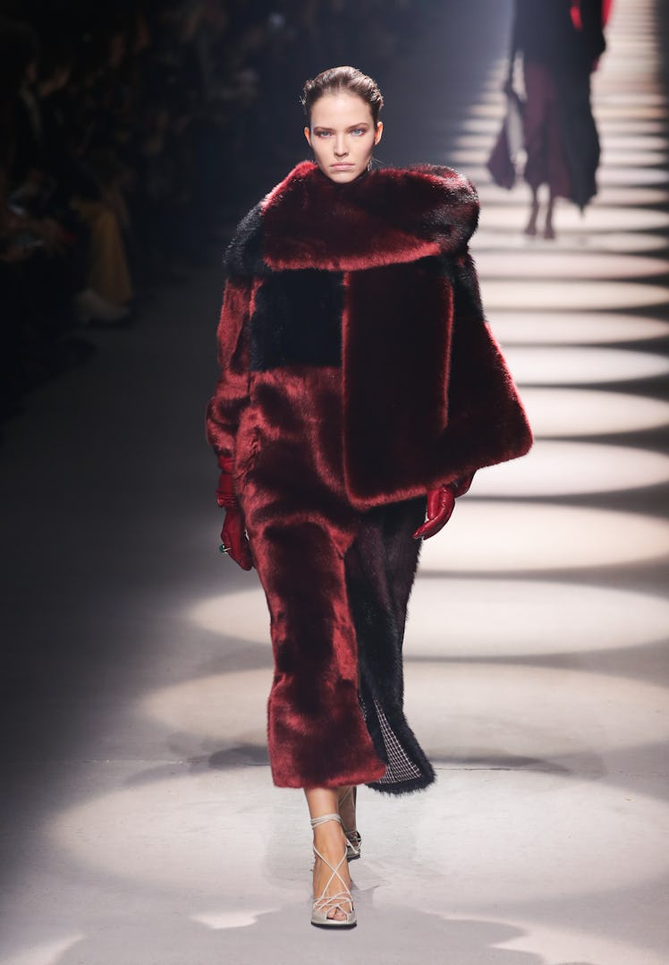 Sasha Luss walking in a burgundy fur coat at Givenchy runway show