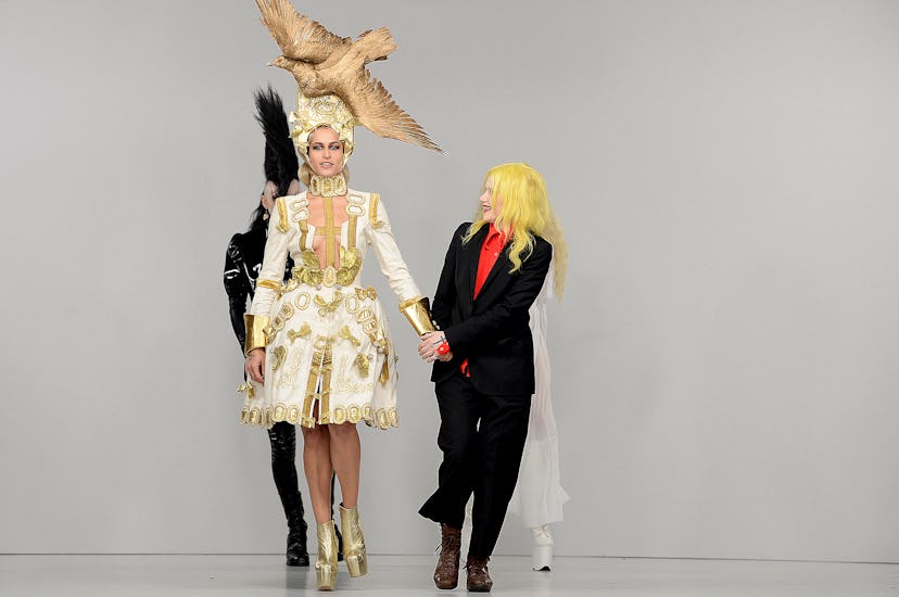 Two models walking at the London Fashion Week in their freak costumes