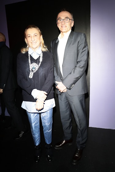 Miuccia Prada and Danny Boyle posing for a photo at the Prada show during Milan Fashion Week