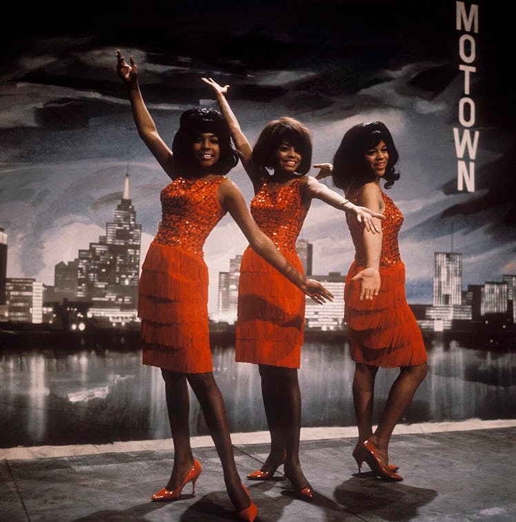 Diana Ross, Florence Ballard, and Mary Wilson wearing red dresses as the Supremes