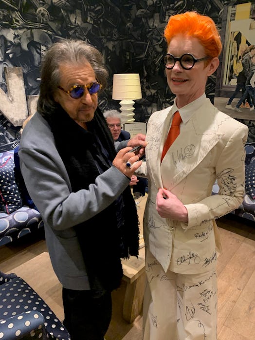 Sandy Powell taking a signature from Al Pacino on her white suit costume
