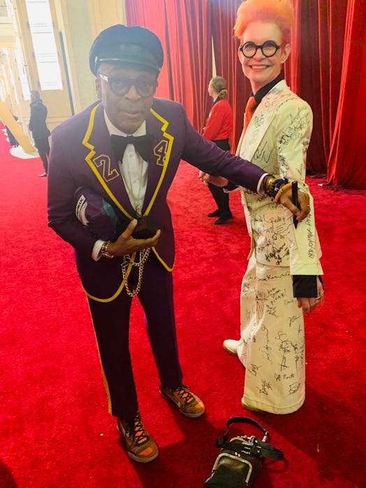 Sandy Powell taking a signature from Spike Lee on her white suit costume