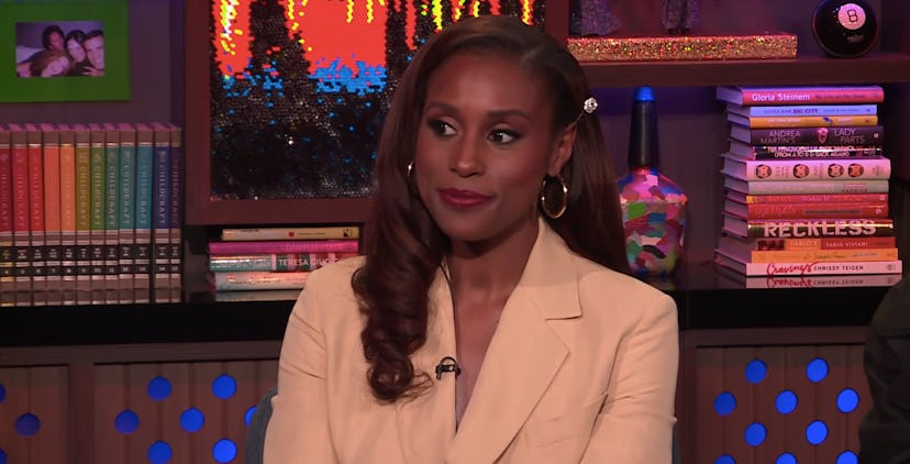 Issa Rae sitting in a beige blazer