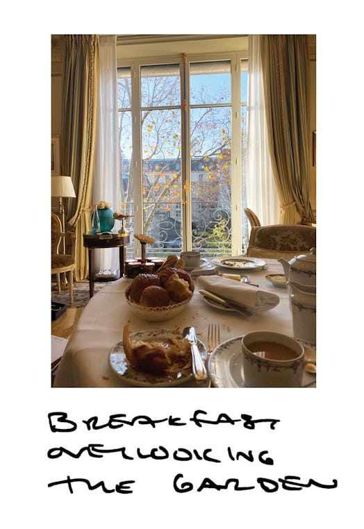 A large table with breakfast food and a large window in the back during a sunny day