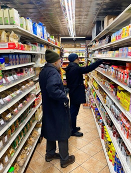 Shore and Baumbach looking at shelfs full of products in a grocery store