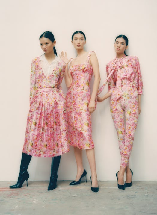Three female models posing in pink floral outfits