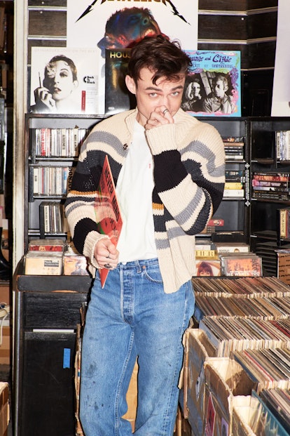 Thomas Doherty stands before a stack of records.