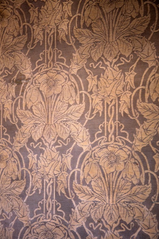 A close-up of the brown floral wallpaper at Olivier Theysken's Paris Studio