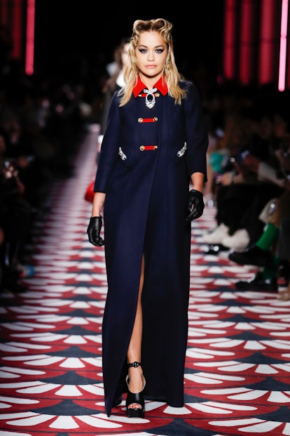 Rita Ora wearing a navy coat with a red collar on the Fashion Week Fall 2020