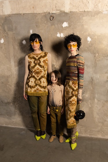 Two adult and one child model wearing pieces by Marine Serre backstage