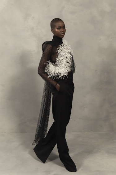 A model in a black jumpsuit with white feather detail at the Givenchy Fall 2020 show