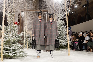 Models on Thom Browne's fall 2020 runway during Paris Fashion Week in plaid jackets and lace headpie...