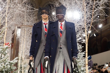 Models on Thom Browne's fall 2020 runway during Paris Fashion Week in navy blue jackets, grey suits ...