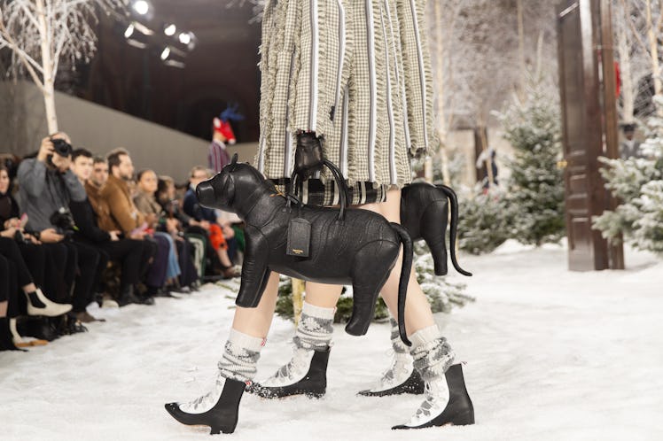 Models on Thom Browne's runway during Paris Fashion Week carrying dog-shaped bags
