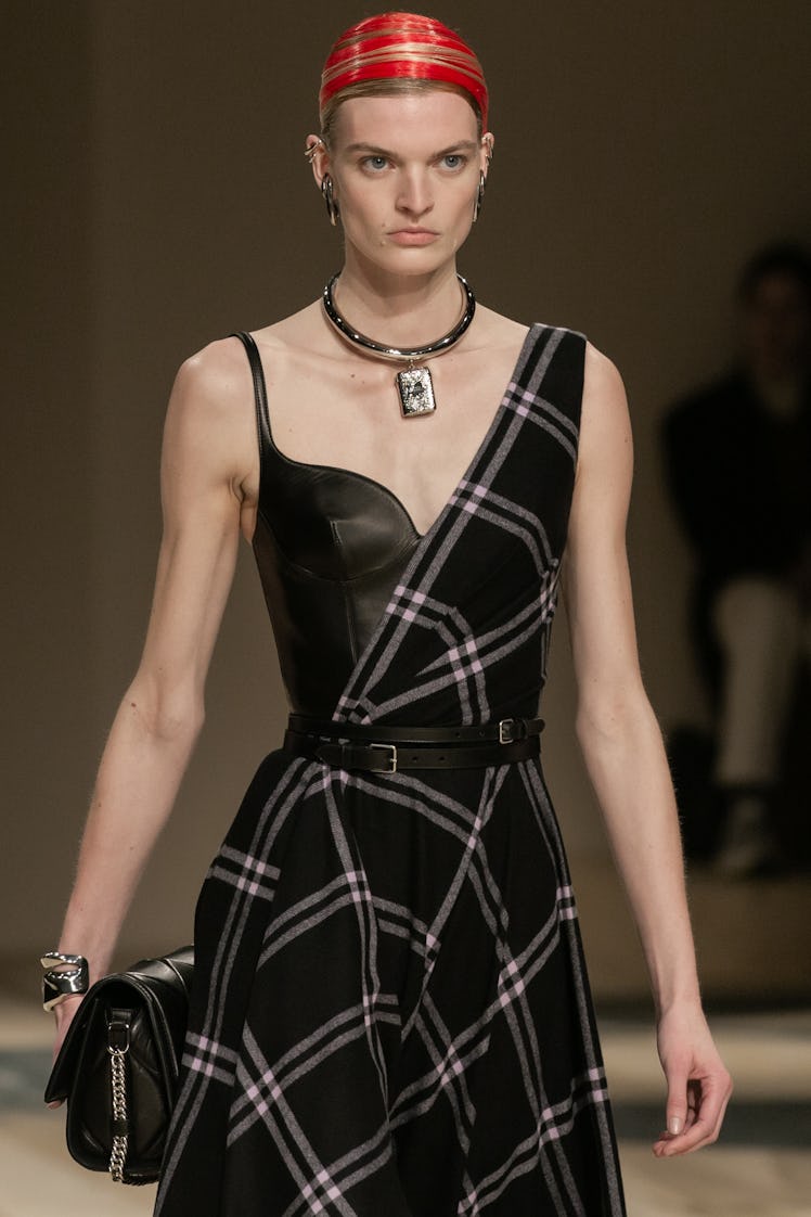 A model in a black asymmetric dress at the Alexander McQueen Fall 2020 show