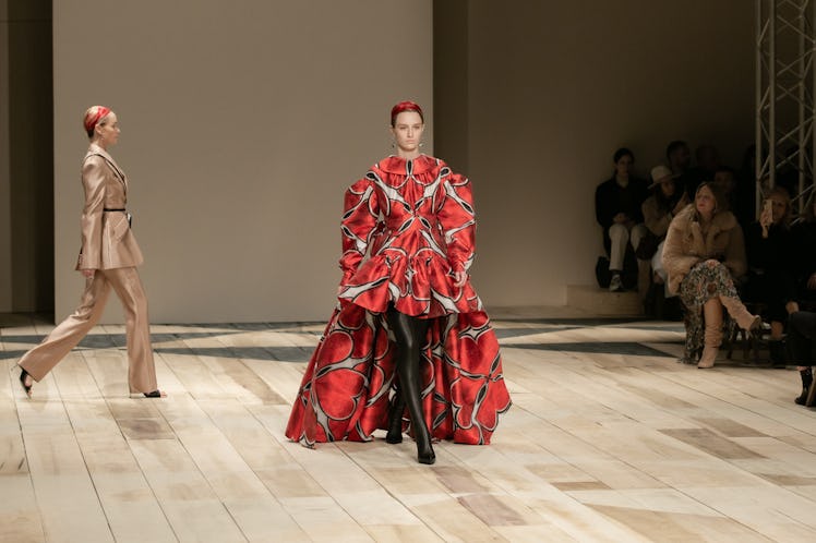 A model in a red-white-black dress-coat at the Alexander McQueen Fall 2020 show