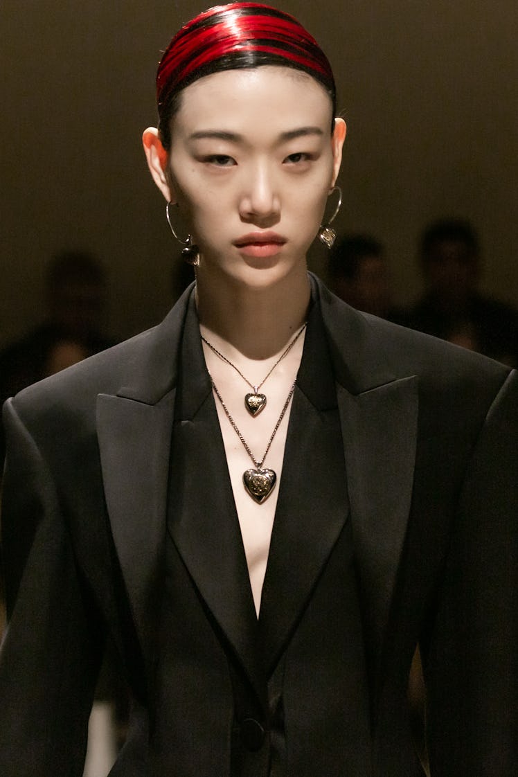 A model in a black shirt and coat at the Alexander McQueen Fall 2020 show