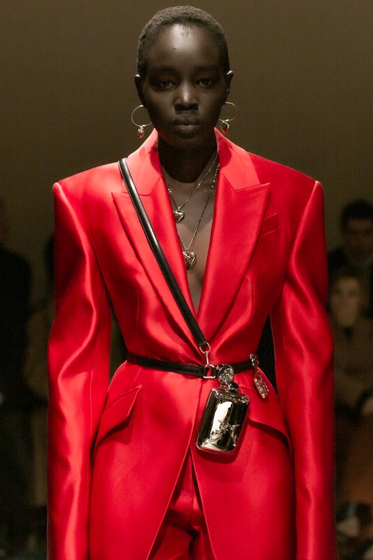 A model in a red satin suit at the Alexander McQueen Fall 2020 show