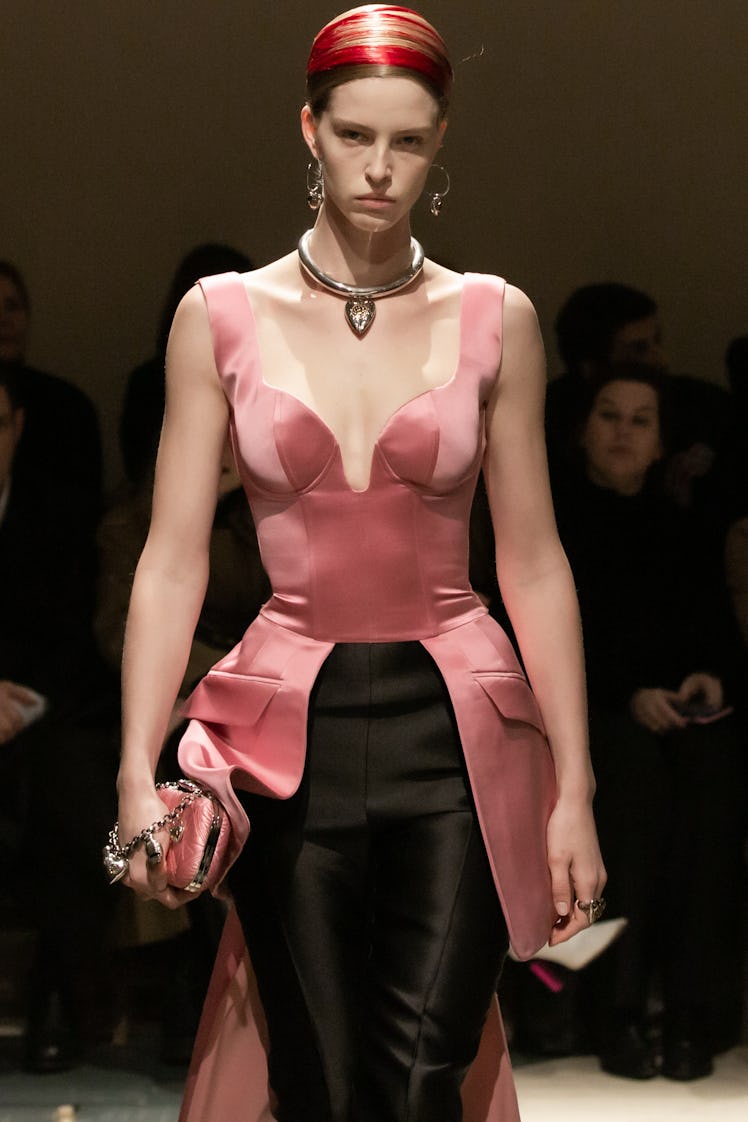 A model in a pink corset and black trousers at the Alexander McQueen Fall 2020 show
