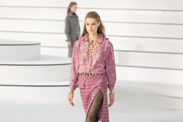 A model in a pink shirt and a pink tweed skirt at the Chanel fall 2020 show