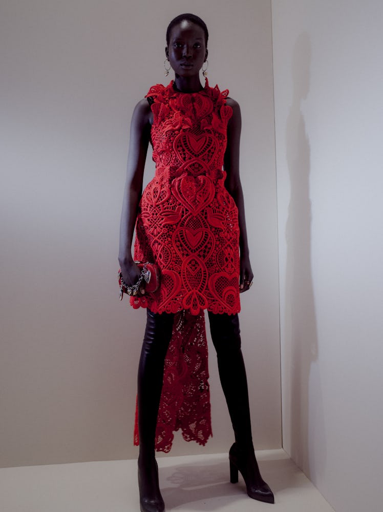 A model in a red lace dress at the Alexander McQueen Fall 2020 show