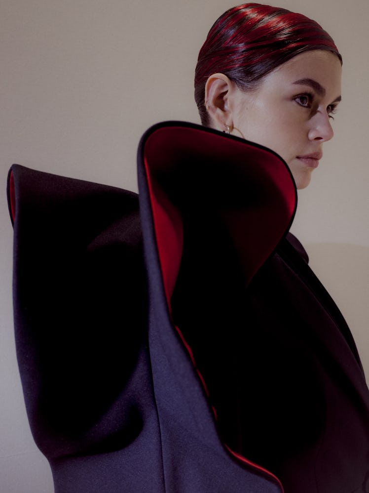 Kaia Gerber's side profile in a black-red coat at the Alexander McQueen Fall 2020 show