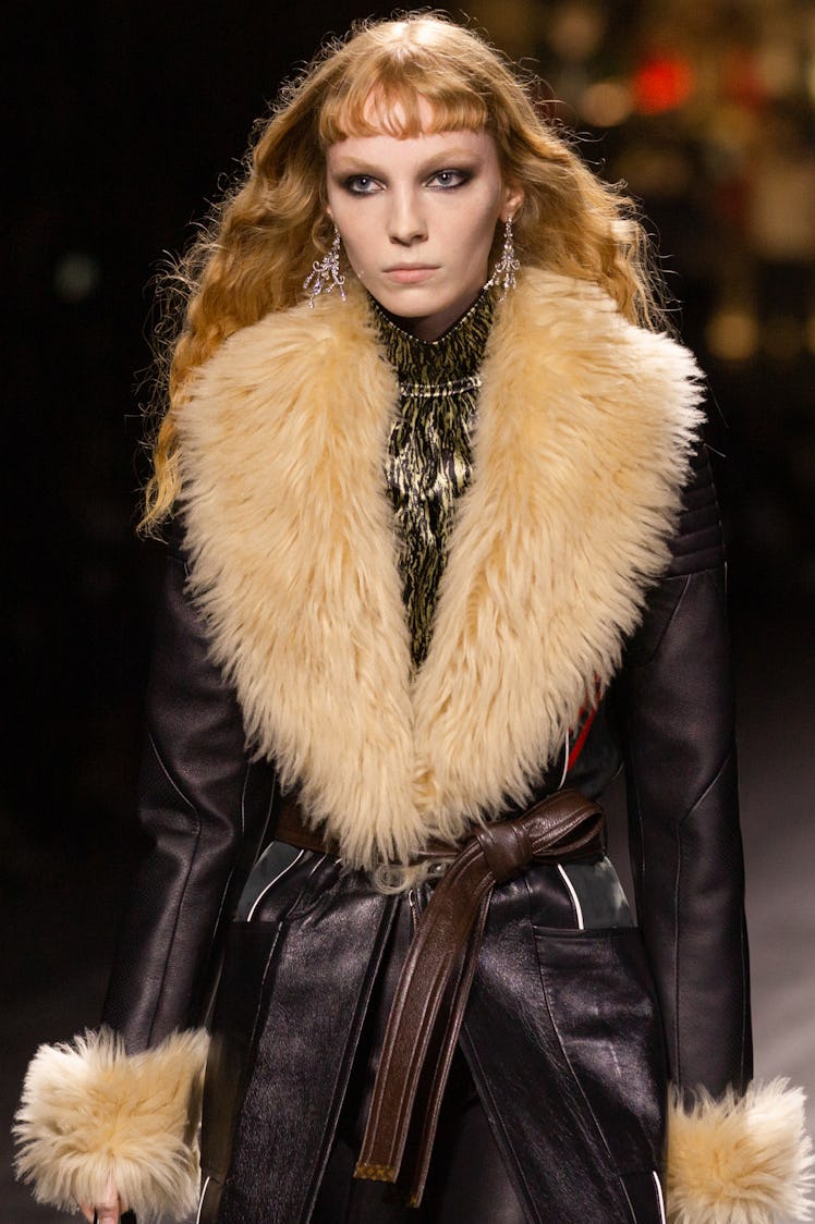 A model in a brown leather coat with beige neck fur at the Louis Vuitton fall 2020 show
