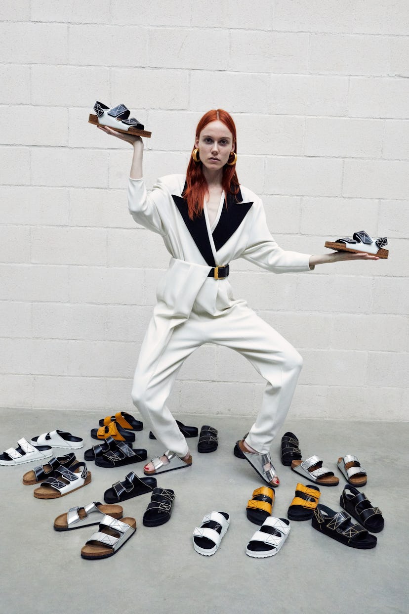 A female model posing with a lot of Proenza Schouler and Birkenstock boots and mules