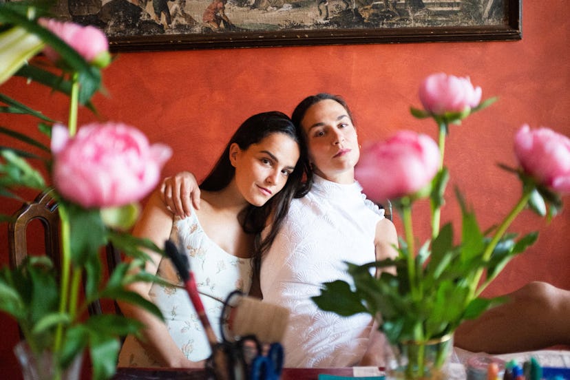Chiara and Gioia Bini dressed in white, hugging at their home in Florence, Italy. 