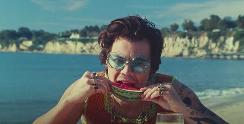 A screenshot of Harry Styles biting into a watermelon in the music video for Watermelon Sugar