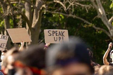 A protest sign that reads "Speak Up"