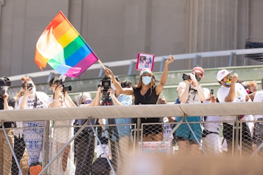 An attendant waving a rainbow LGBT flag at the Brooklyn Liberation