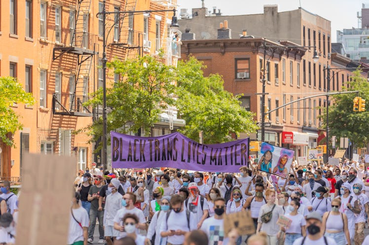 Brooklyn Liberation attendants marching with a big purple parol
