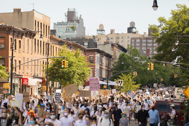 Brooklyn Liberation attendants marching while wearing white shirts
