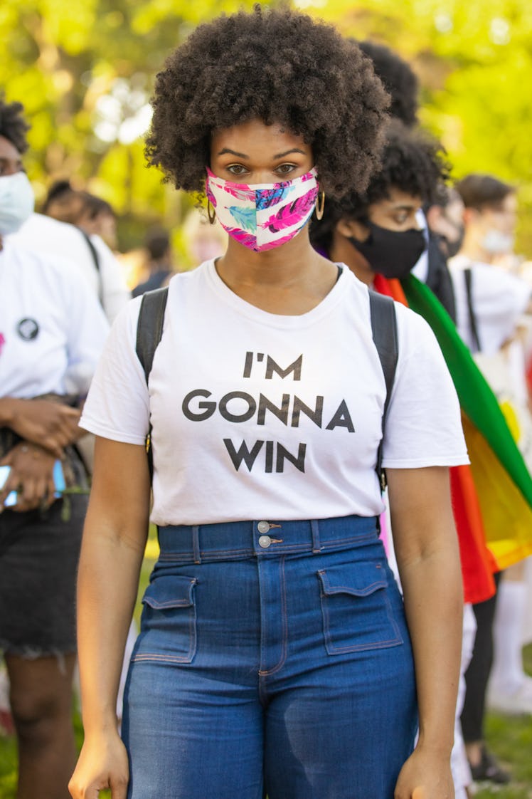 Brooklyn Liberation attendant marching in a white shirt with "I'M GONNA WIN" text