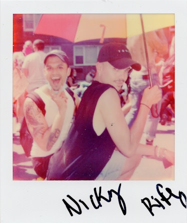 A polaroid shot of two people smiling and posing at the New York City Pride March with the text 'Nic...