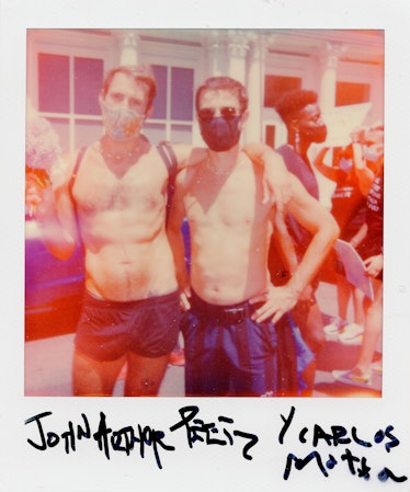 A polaroid shot of two people standing and posing at the New York City Pride March with a slightly b...