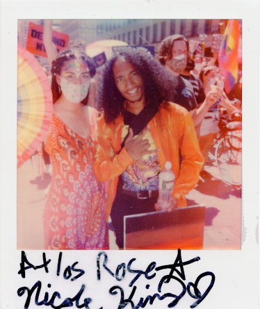 Two people in a polaroid shot at the New York City Pride March with the text 'Atlas Rose Nicole Kim'