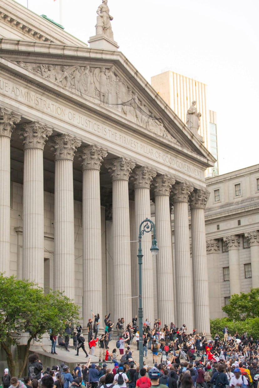 A group of protesters assembled in front of the Supreme Court of New York City.