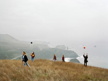 Group of girls playing with balls on a hill top