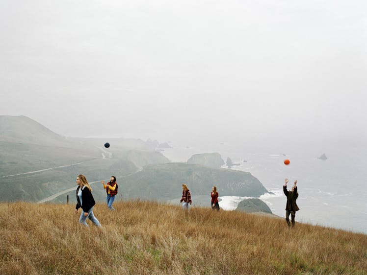 Group of girls playing with balls on a hill top