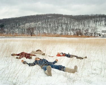 Four girls lying on snow ground
