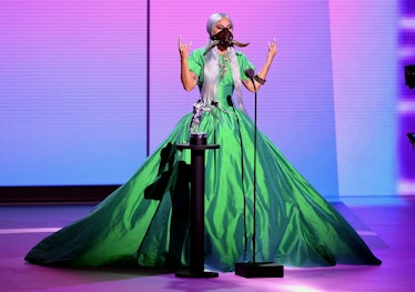 Lady gaga in a large green gown and a black face mask at the MTV VMAs 2020