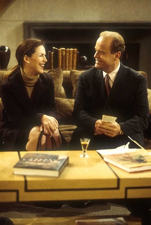 Roz Doyle and Frasier Crane sitting on a couch and laughing 