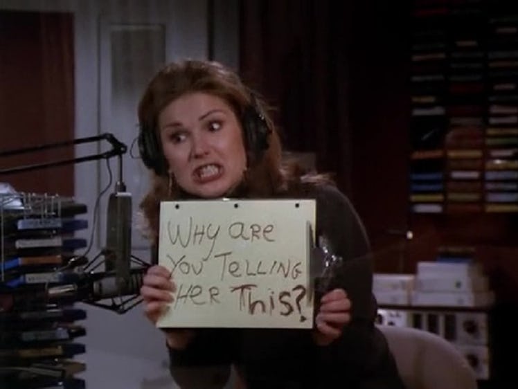 Roz Doyle holding a paper that says "why are you telling her this?" from the outside of a recording ...
