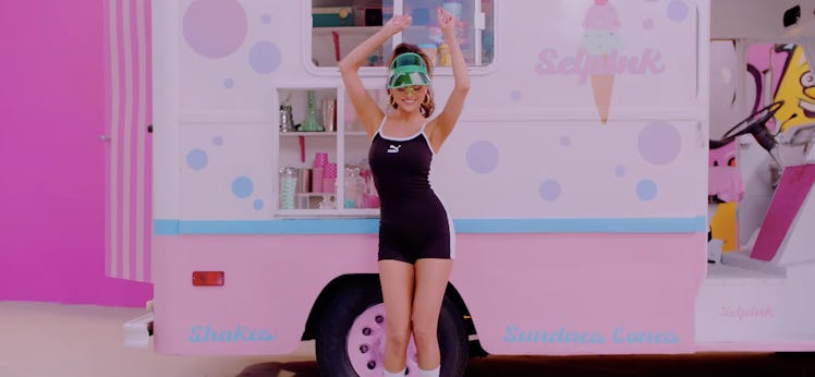 Selena Gomez in a black mini dress in front of a pink ice cream truck 