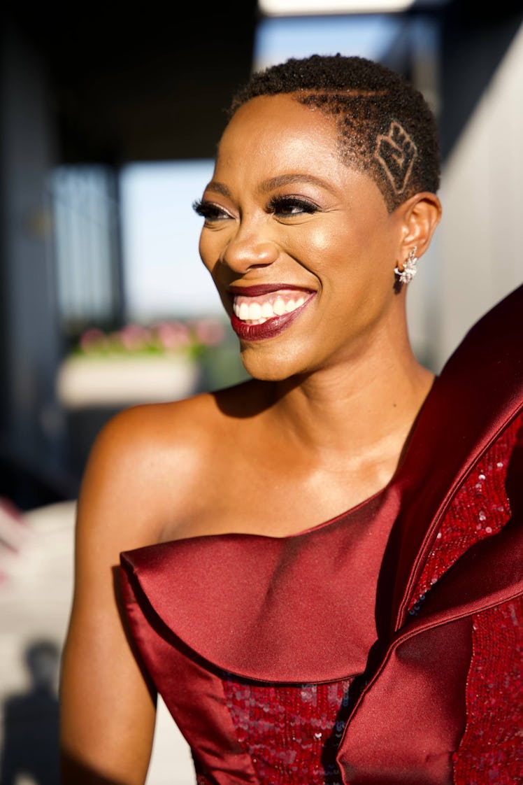 Yvonne Orji smiling while wearing a red gown 